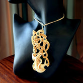Hand carved bone manaia pendant. This is a complex carving by New Zealand carver and artist, Andrew Doughty. It is an intricate representation of a manaia carved to represent protection. It can be worn but is also a quality that warrants display.